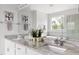 Spa-like bathroom with granite countertops, dual sinks, and a soaking tub under a bright window at 296 Two Creeks Lp, Chapel Hill, NC 27517
