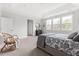 Primary bedroom showcasing a large bed, trey ceiling, big windows, and access to the ensuite bathroom at 296 Two Creeks Lp, Chapel Hill, NC 27517