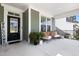 Relaxing front porch with wicker chairs and potted plants at 296 Two Creeks Lp, Chapel Hill, NC 27517