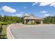 Beautiful guard house at the entrance to a gated community with professional landscaping and mature trees at 296 Two Creeks Lp, Chapel Hill, NC 27517
