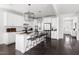 Bright, spacious kitchen with white cabinetry, modern appliances, and a large center island with barstool seating at 296 Two Creeks Lp, Chapel Hill, NC 27517