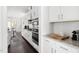 Modern kitchen featuring white cabinets, stainless steel appliances, and granite countertops at 296 Two Creeks Lp, Chapel Hill, NC 27517
