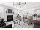 Open living room with fireplace, modern lighting, and seamless flow to kitchen at 296 Two Creeks Lp, Chapel Hill, NC 27517
