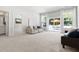 Light-filled living room with large windows, an outdoor view, neutral paint, and plush carpeting at 296 Two Creeks Lp, Chapel Hill, NC 27517