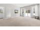 Spacious living room with plush carpeting, natural light from the large windows and a glimpse of a bathroom at 296 Two Creeks Lp, Chapel Hill, NC 27517