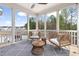 Cozy screened porch furnished with wicker furniture, providing an inviting outdoor space for relaxation at 296 Two Creeks Lp, Chapel Hill, NC 27517