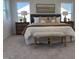 A modern bedroom with neutral colored walls, carpet, and a large bed with decorative pillows at 4327 Emeline Way # 10, Fuquay Varina, NC 27526