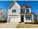 Two-story house with white siding, gray accents, and a two-car garage at 4327 Emeline Way # 10, Fuquay Varina, NC 27526