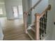 Elegant staircase featuring wood and black metal accents leading to the upper level at 4327 Emeline Way # 10, Fuquay Varina, NC 27526