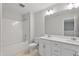 Bright bathroom featuring a double sink vanity, a tub with shower, and neutral color palette at 545 Eversden Dr, Zebulon, NC 27597