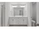 Bright bathroom featuring double sinks, and a large vanity with white cabinetry at 545 Eversden Dr, Zebulon, NC 27597