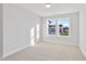 Bedroom with neutral walls and carpet features a large window with neighborhood views at 545 Eversden Dr, Zebulon, NC 27597