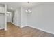 Bright dining room featuring wood-look floors, a modern chandelier, and neutral paint at 545 Eversden Dr, Zebulon, NC 27597