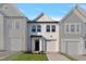 Charming new construction home with attached garage, white siding, and well manicured lawn at 545 Eversden Dr, Zebulon, NC 27597