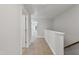 Upstairs hallway featuring neutral walls, carpet flooring, and a view of a naturally lit room at 545 Eversden Dr, Zebulon, NC 27597