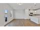 Open-concept kitchen and living room with wood flooring, recessed lighting, and lots of natural light at 545 Eversden Dr, Zebulon, NC 27597