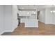 Open-concept kitchen and living room with wood flooring, recessed lighting, and natural light at 545 Eversden Dr, Zebulon, NC 27597