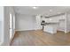 Open-concept kitchen and living room with wood flooring, recessed lighting, and lots of natural light at 545 Eversden Dr, Zebulon, NC 27597