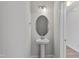 Charming powder room featuring a pedestal sink, oval mirror and modern sconces at 545 Eversden Dr, Zebulon, NC 27597
