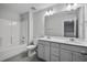 Well-lit bathroom with double vanity, shower-tub combo, and modern fixtures at 556 Eversden Dr, Zebulon, NC 27597