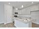 Modern kitchen featuring white cabinets, granite countertops, stainless appliances, and a center island with pendant lighting at 556 Eversden Dr, Zebulon, NC 27597