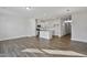 Open concept kitchen featuring white cabinets, stainless steel appliances, and a central island with a breakfast bar at 556 Eversden Dr, Zebulon, NC 27597