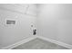 Functional laundry room with tile flooring, wire shelving, and hookups for a washer and dryer for added convenience at 556 Eversden Dr, Zebulon, NC 27597