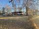 Large backyard with mature trees and chain link fence at 6416 Diamond Dr, Raleigh, NC 27610