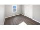 Well-lit bedroom featuring hardwood floors and closet at 708 N Allen Rd, Wake Forest, NC 27587