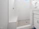 Tiled shower with pebble floor, shower niche, and bench inside of this bright bathroom at 95 Purslane Dr, Franklinton, NC 27525