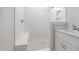 Bathroom featuring shower with tiled walls and floor, built-in shelving, and a white vanity with granite counter at 95 Purslane Dr, Franklinton, NC 27525