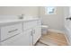 Bathroom with white vanity, granite countertops, and wood look flooring at 95 Purslane Dr, Franklinton, NC 27525