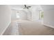 Bright bedroom with plush carpeting, ceiling fan, and two windows offering natural light at 95 Purslane Dr, Franklinton, NC 27525