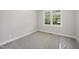 Bedroom with bright windows and neutral carpeting at 95 Purslane Dr, Franklinton, NC 27525