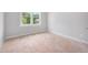 A well-lit bedroom with a double window and bare floors at 95 Purslane Dr, Franklinton, NC 27525