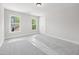 Neutral bedroom with plush carpeting, two windows, and ceiling light at 95 Purslane Dr, Franklinton, NC 27525