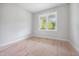 A Bedroom featuring a double window with white trim and bare floors at 95 Purslane Dr, Franklinton, NC 27525