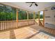 View from inside of a covered porch featuring wood flooring, railing, and ceiling fan at 95 Purslane Dr, Franklinton, NC 27525