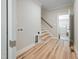 Inviting entryway with hardwood floors, stairs, and access to the garage, laundry and storage at 95 Purslane Dr, Franklinton, NC 27525
