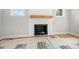 Modern fireplace design with a wooden mantel and white shiplap surround in a light-filled room at 95 Purslane Dr, Franklinton, NC 27525
