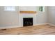Close up of modern fireplace with light wood mantel and shiplap wall at 95 Purslane Dr, Franklinton, NC 27525