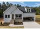 Charming single-Gathering home featuring stone accents, gray siding, attached garage, and a welcoming front porch at 95 Purslane Dr, Franklinton, NC 27525