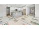 Open-concept kitchen featuring white cabinets, gray island with granite countertops, and stainless steel appliances at 95 Purslane Dr, Franklinton, NC 27525