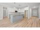 Well-lit kitchen showcases white cabinets, large island, and stainless appliances at 95 Purslane Dr, Franklinton, NC 27525