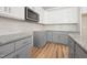 Gray and white kitchen features a microwave, backsplash, and granite countertops at 95 Purslane Dr, Franklinton, NC 27525
