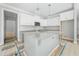 New kitchen featuring a gray island, white cabinets, granite countertops, and stainless steel microwave at 95 Purslane Dr, Franklinton, NC 27525