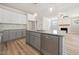 Kitchen island with stainless dishwasher and view of the open floor plan at 95 Purslane Dr, Franklinton, NC 27525