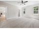 Main bedroom with neutral carpeting, bright windows, and entry into main bathroom and closet at 95 Purslane Dr, Franklinton, NC 27525