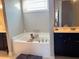 Relaxing bathroom with a soaking tub, dual vanities, and modern fixtures at 108 Kaspurr Dr, Garner, NC 27529