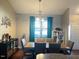Dining area with modern light fixture and large windows providing ample natural light at 108 Kaspurr Dr, Garner, NC 27529